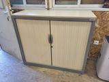 a cabinet that has two doors and a door handle on it