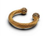a close up of a gold bracelet with two black stones