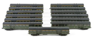 several model trains are lined up in rows on a white surface