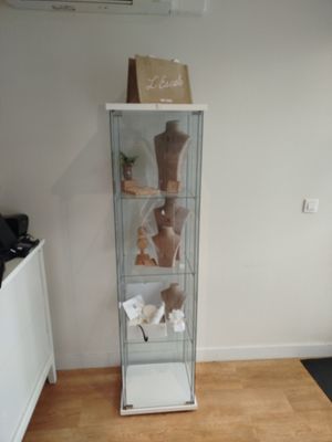 une vitrine en verre dans le coin d'une pièce