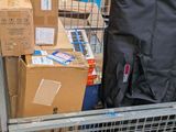 a cart full of boxes and luggage in the back of a truck