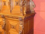 a wooden dresser in a room with a rug on the floor