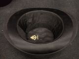 a black hat that is sitting in a black bowl