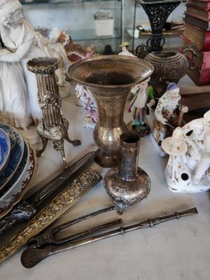 a table with a lot of antique items on it