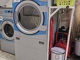 a stack of washers and dryers in a laundry room