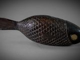 a small wooden fish that is sitting on a table