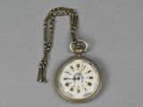 a gold pocket watch with roman numerals on it