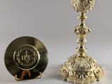 une assiette en argent avec une tasse en argent et une assiette en argent posées sur un fond blanc