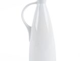 a white pitcher with a handle on a white background