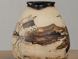 a vase with a picture of a horse on it on a table