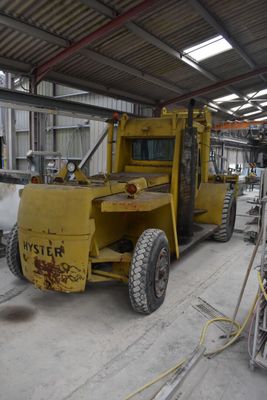 a large yellow truck that is parked in a garage