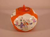 an orange and white vase with a picture of people on it