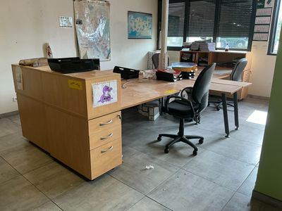 a desk with a chair and a computer on it