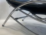 black leather chaise lounger with chrome frame and foot rest