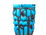 a blue vase sitting on top of a wooden table