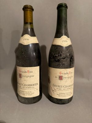 two bottles of wine sitting next to each other on a table
