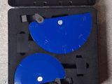 two blue discs in a black case on the floor