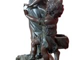 bronze statue of a woman and two children on a table