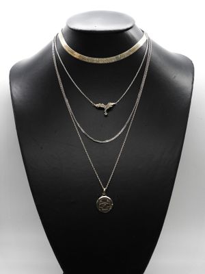a black mannequin with three different necklaces on it