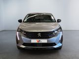 the front view of a silver car parked in a showroom