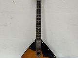 an old guitar hanging on a wall in a room