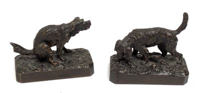 pair of bronze sculptures of a dog and a cat on a rock