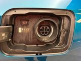 a close up of a car ' s fuel pump with a blue car in the background