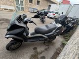 a scooter parked in a parking lot next to a building