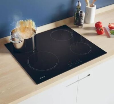 a stove top with a pot on it and a pan on the stove