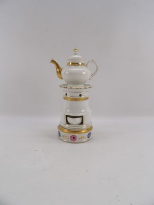 a small white teapot with a gold trim on it