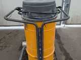 a yellow and black trash can on a cart