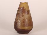 a brown vase with a tree on it on a white surface
