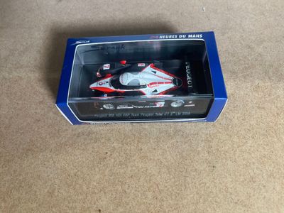 a box with a toy car in it on the floor