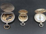 four different types of pocket watches sitting on top of a table