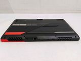 a black laptop with a red trim sitting on a white surface