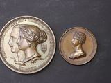 an image of a gold coin with a bust of a woman and a bust of a man