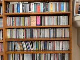 a book shelf with a lot of dvd ' s on it