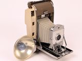 an old photo of a polaroid camera with a lens