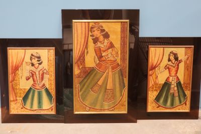 three framed paintings of women in traditional indian dress