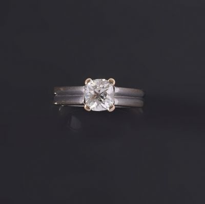 a close up of a diamond ring on a black surface