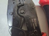 two pliers and a pair of pliers sitting on a table