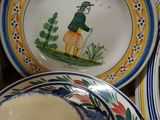 many plates and bowls that are sitting on a table