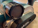 a corded sander sitting on a wooden table