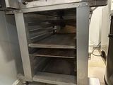 a silver oven that is sitting in a kitchen