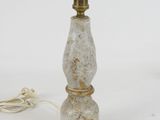 marble lamp with a brass base and a white cord on a white background