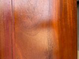 a close up of a wooden table with a clock on it