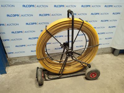 an image of a large yellow hose on a cart