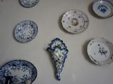de nombreuses assiettes accrochées au mur, ornées de motifs bleus et blancs