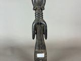 a close up of a statue of a person with a bird on it ' s head
