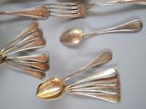several spoons and spoon spoons are arranged on a white surface